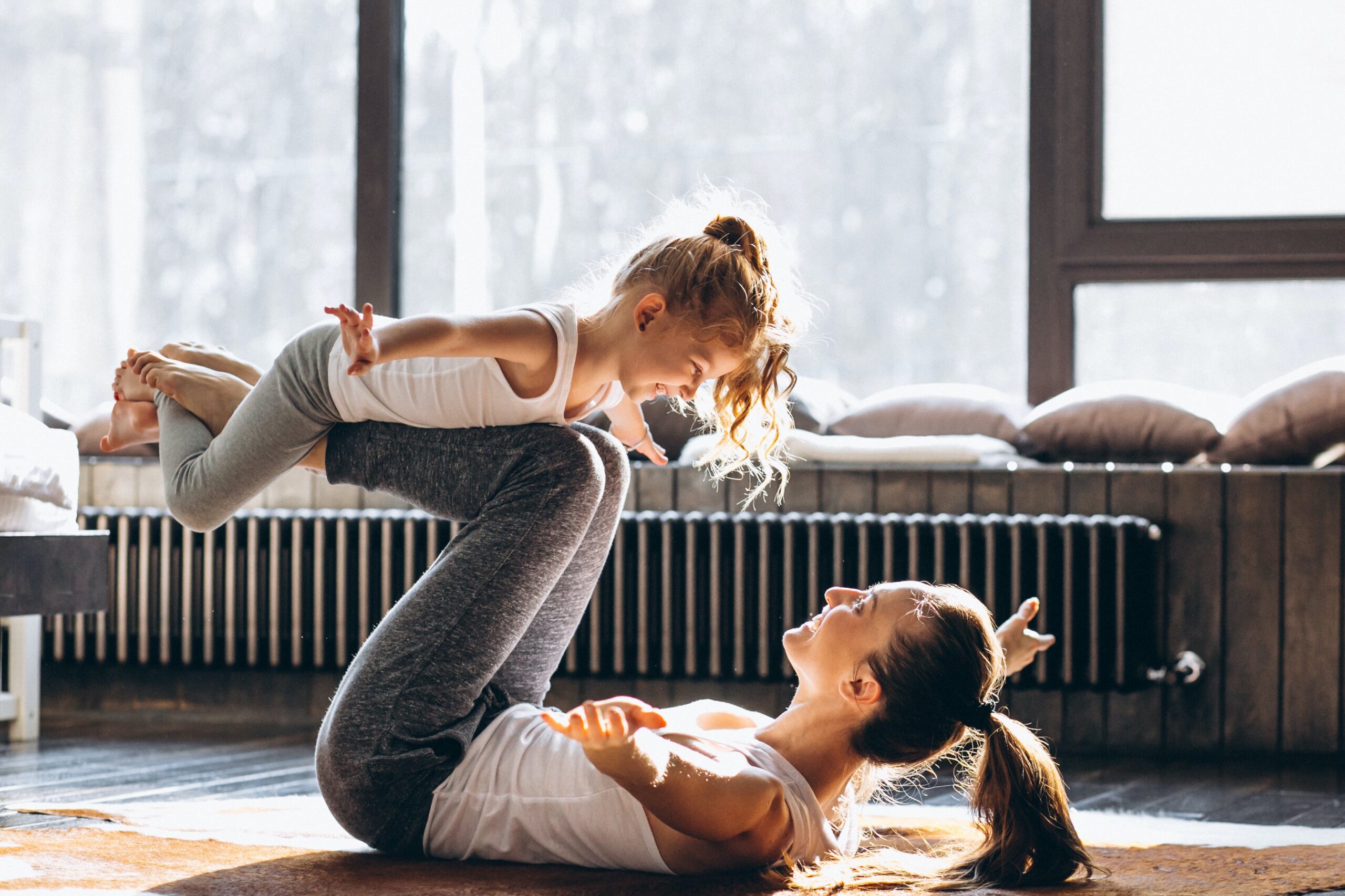 Mother and daughter yoga at home